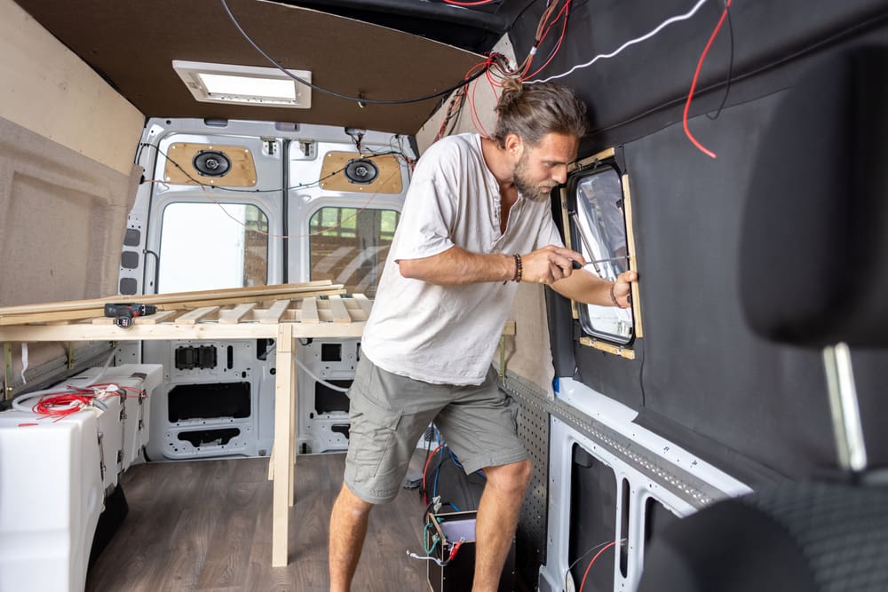 Caucasian man is upfitting the van