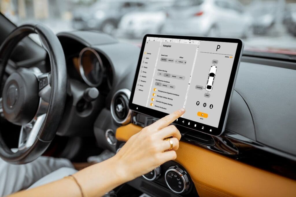 Driver's hand is operating the car's infotainment
