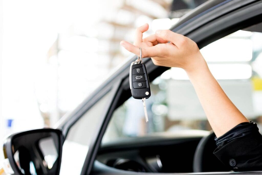 Driver is handling her car remote key to the car mechanic